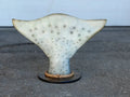 Halibut tail sculpture reproduction on a dark round wood base with a rope ring